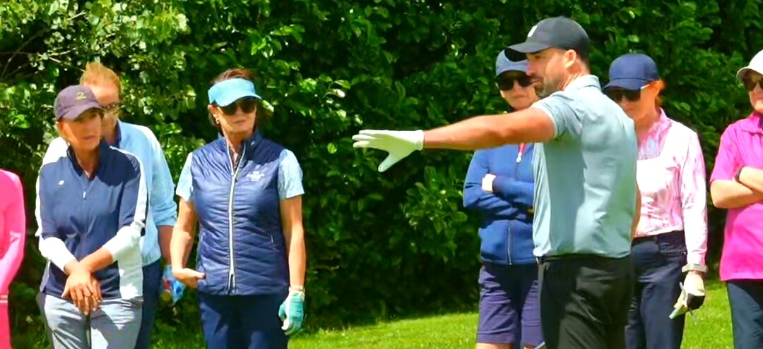 Gary McGrane giving individual putting feedback to a group of lady golfers